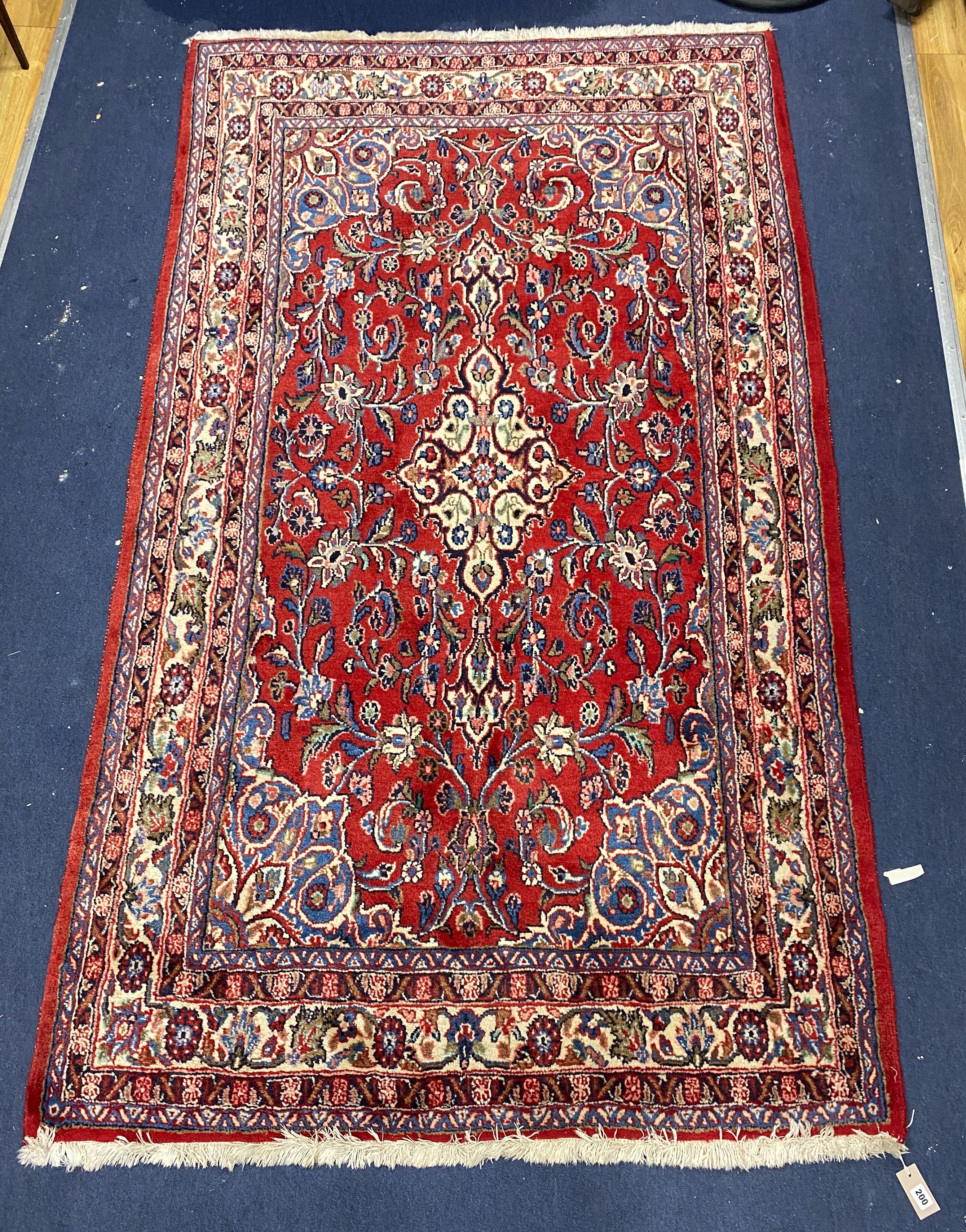 A Northwest Persian red ground rug, 240 cm x 136 cm